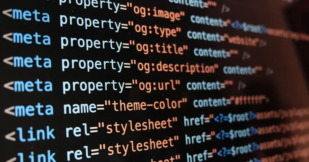 Meta Tags and Technical SEO Code Structure Close-up of HTML meta tags code showing og:image, og:title, og:description and stylesheet links on dark screen